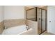 Beautiful bathroom showcasing a soaking tub, walk-in shower, and modern tilework at 1323 Faircrest Way, Suwanee, GA 30024