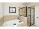 Modern bathroom with a soaking tub and walk-in shower with a glass enclosure at 1323 Faircrest Way, Suwanee, GA 30024