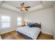 Comfortable bedroom with hardwood floors, ceiling fan, and ample natural light from two windows at 1323 Faircrest Way, Suwanee, GA 30024