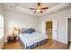 Spacious bedroom with hardwood floors leading to an ensuite bathroom featuring a large soaking tub at 1323 Faircrest Way, Suwanee, GA 30024