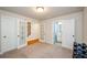 Spacious bonus room featuring French doors, natural light, and neutral tones at 1323 Faircrest Way, Suwanee, GA 30024
