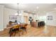 Bright dining area adjacent to the kitchen, featuring a modern light fixture and wood floors at 1323 Faircrest Way, Suwanee, GA 30024