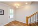 Bright foyer featuring hardwood floors and staircase at 1323 Faircrest Way, Suwanee, GA 30024