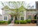 Charming brick townhome featuring a landscaped front yard and inviting entryway at 1323 Faircrest Way, Suwanee, GA 30024
