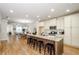 Open-concept kitchen with an island featuring seating, connected to the dining and living area at 1323 Faircrest Way, Suwanee, GA 30024