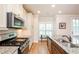 Close-up of stainless steel appliances, granite countertops, and hardwood floors at 1323 Faircrest Way, Suwanee, GA 30024