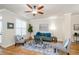Cozy living room with hardwood floors, a ceiling fan, and comfortable seating at 1323 Faircrest Way, Suwanee, GA 30024