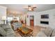 Cozy living room featuring a fireplace, ceiling fan, hardwood floors, and comfortable seating at 1323 Faircrest Way, Suwanee, GA 30024