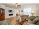 Cozy living room featuring a stone fireplace and hardwood floors at 1323 Faircrest Way, Suwanee, GA 30024