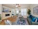 Cozy living room featuring a stone fireplace, hardwood floors, and an open layout at 1323 Faircrest Way, Suwanee, GA 30024
