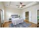 Inviting main bedroom showcasing tray ceilings, hardwood floors, and bright windows at 1323 Faircrest Way, Suwanee, GA 30024
