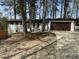 Inviting exterior view of a single-story home with well-maintained landscaping and attached garage at 3185 Hammarskjold Dr, East Point, GA 30344