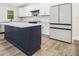 Charming kitchen with island, white cabinets, modern appliances, and stylish herringbone backsplash at 3185 Hammarskjold Dr, East Point, GA 30344