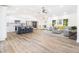 Open floor plan showcasing the kitchen, living room, and dining area with sleek hardwood floors at 3185 Hammarskjold Dr, East Point, GA 30344
