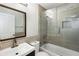 Bathroom with light brown tile, glass enclosed shower and dark wood vanity at 3795 Soapstone Rd, Decatur, GA 30034