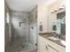 Bathroom with a stone tile shower with glass door, white vanity and granite countertop at 3795 Soapstone Rd, Decatur, GA 30034