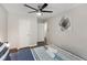 Bedroom featuring gray wood flooring, ceiling fan, and floral wall art above the bed at 3795 Soapstone Rd, Decatur, GA 30034