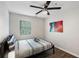 Bedroom with gray wood flooring, ceiling fan, and colorful wall art above the bed at 3795 Soapstone Rd, Decatur, GA 30034
