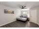 Bedroom featuring gray wood flooring, ceiling fan, and skyline wall art above the bed at 3795 Soapstone Rd, Decatur, GA 30034