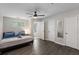 Bedroom featuring gray wood flooring, ceiling fan, and open doorway at 3795 Soapstone Rd, Decatur, GA 30034