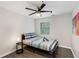 Bedroom featuring gray wood flooring, ceiling fan, and colorful wall art above the bed at 3795 Soapstone Rd, Decatur, GA 30034