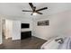 Bedroom featuring gray wood flooring, ceiling fan, and TV above dresser at 3795 Soapstone Rd, Decatur, GA 30034