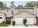 Charming townhouse showcasing a well-maintained facade, brick accents, and a convenient attached garage at 3795 Soapstone Rd, Decatur, GA 30034