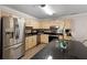Updated kitchen with stainless steel appliances, granite countertops, and stylish cabinetry, offering a modern and functional space at 3795 Soapstone Rd, Decatur, GA 30034