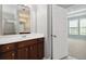Bathroom vanity with double sinks and storage, next to an open door to a bedroom at 4114 Bigsage Dr, College Park, GA 30349