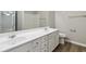 A bright bathroom with a double vanity, mirror, and a view into the shower/tub area at 4114 Bigsage Dr, College Park, GA 30349