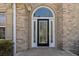 Elegant front entrance featuring a black door with decorative glass and sidelights, set in a brick facade at 4114 Bigsage Dr, College Park, GA 30349