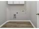 A minimalist laundry room space with hookups and overhead storage at 4114 Bigsage Dr, College Park, GA 30349
