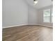 Bright living room featuring vaulted ceilings, large windows, and neutral paint tones, creating a welcoming space at 4114 Bigsage Dr, College Park, GA 30349