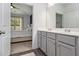 Bathroom featuring double sink vanity and walk-in shower, adjacent to the primary bedroom at 515 Vandenburg Dr, Villa Rica, GA 30180