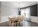 Elegant dining room with a wooden table, white chairs, decorative lighting, and modern decor at 515 Vandenburg Dr, Villa Rica, GA 30180