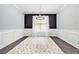 Formal dining room featuring modern wainscotting, dramatic decor, and a stylish area rug at 515 Vandenburg Dr, Villa Rica, GA 30180
