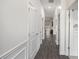 Bright hallway featuring wood floors and white trim, leading to various rooms at 515 Vandenburg Dr, Villa Rica, GA 30180