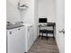Laundry room with washer, dryer, shelving and desk for convenience at 515 Vandenburg Dr, Villa Rica, GA 30180