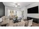 Comfortable living room with modern decor, large windows, and a ceiling fan at 515 Vandenburg Dr, Villa Rica, GA 30180