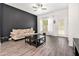 Bright living room with a black accent wall, neutral furniture, and a window with natural light at 515 Vandenburg Dr, Villa Rica, GA 30180
