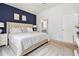 Bright main bedroom with a vaulted ceiling, dark accent wall, and access to the ensuite bathroom at 515 Vandenburg Dr, Villa Rica, GA 30180