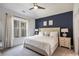 Inviting primary bedroom with a tufted headboard, soft lighting, and a large window at 515 Vandenburg Dr, Villa Rica, GA 30180