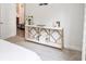 Stylish main bedroom features a console table, providing both decor and storage, and a glimpse into the kitchen at 515 Vandenburg Dr, Villa Rica, GA 30180