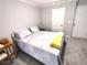 Cozy bedroom featuring soft carpet, a comfy queen bed with throw blanket, and neutral wall color at 703 Gettysburg Pl, Atlanta, GA 30350