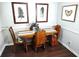 Charming dining area features a wooden table set, hardwood floors, and decorative wall art, creating a cozy atmosphere at 703 Gettysburg Pl, Atlanta, GA 30350