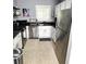 Well-lit kitchen with white cabinets, stainless steel appliances, granite countertops, and tile flooring at 703 Gettysburg Pl, Atlanta, GA 30350