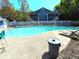 Community pool surrounded by lounge chairs and a white picket fence for relaxation and recreation at 703 Gettysburg Pl, Atlanta, GA 30350