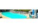 Community pool with tables and chairs for entertaining, set against a backdrop of lush greenery at 703 Gettysburg Pl, Atlanta, GA 30350