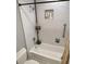 Modern bathroom featuring a white subway tile shower with a built-in niche and matte black fixtures and accessories at 703 Gettysburg Pl, Atlanta, GA 30350