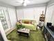 Cozy sunroom with bright green carpet, large windows and natural light at 703 Gettysburg Pl, Atlanta, GA 30350